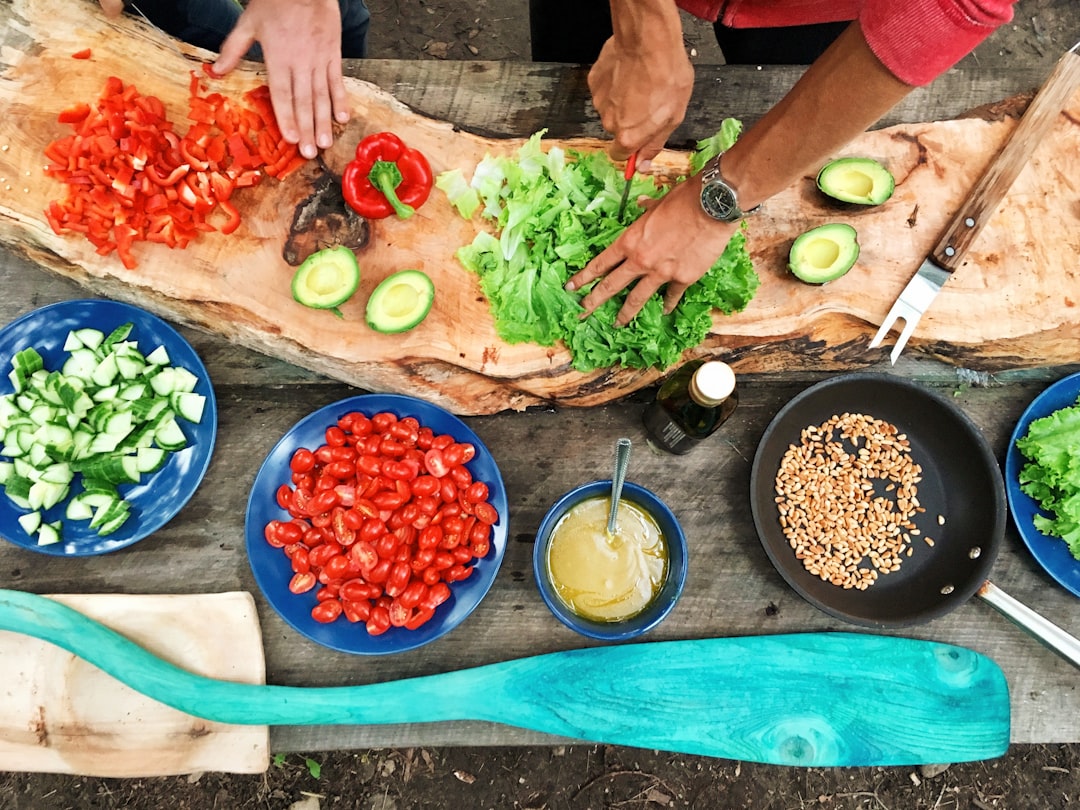 product-04 person-slicing-green-vegetable-in-front-of-round-ceramic-plates-with-assorted-sliced-vegetables-during-daytime-ezh46xcdqry